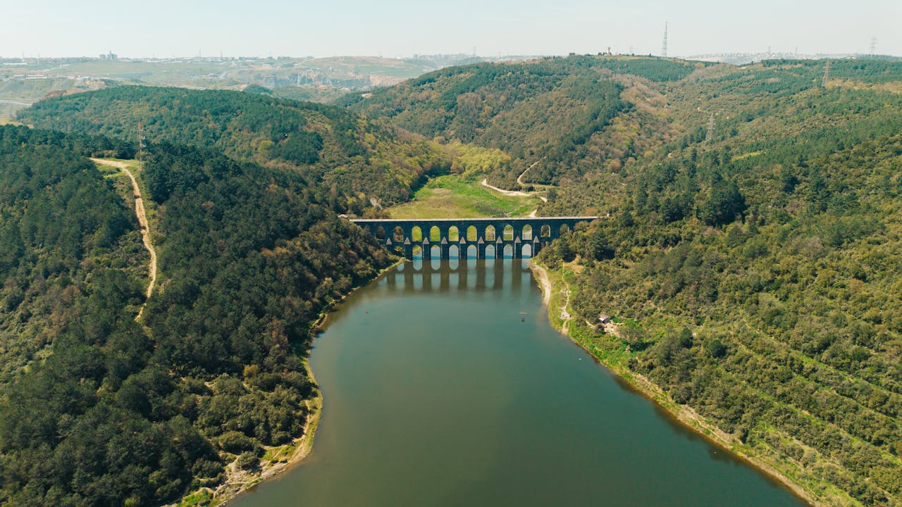 services-03 A breathtaking aerial view captures the historic Valens Aqueduct arching over lush landscapes.